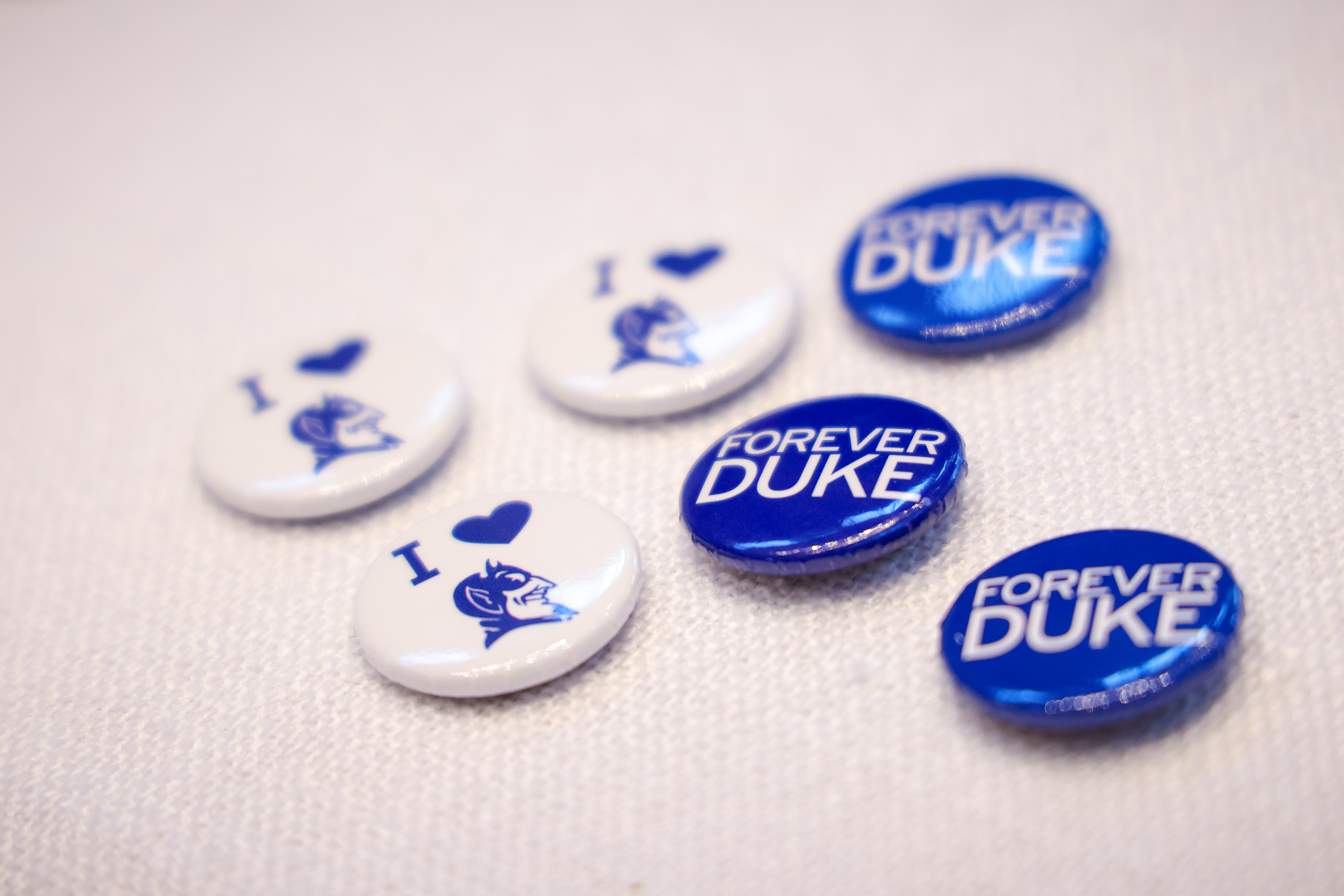 Duke buttons on an off-white background